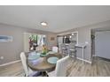 Bright dining room with contemporary floors and a view into the kitchen from the bar top seating area at 700 Starkey Rd # 514, Largo, FL 33771