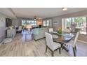 Sun-filled living room featuring modern flooring, a ceiling fan, comfortable seating, and picturesque outdoor views at 700 Starkey Rd # 514, Largo, FL 33771
