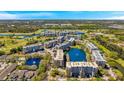 Overhead view of a condo community with pools, water features, green spaces, and manicured landscaping at 960 Starkey Rd # 5303, Largo, FL 33771