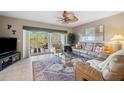 Inviting living room featuring stylish furnishings, a ceiling fan, and a sliding glass door leading to a balcony at 960 Starkey Rd # 5303, Largo, FL 33771
