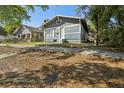 Blue home featuring traditional architecture, landscaping and curb appeal at 1004 E 22Nd Ave, Tampa, FL 33605