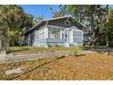 Inviting blue house with tidy lawn and neighborhood views at 1004 E 22Nd Ave, Tampa, FL 33605