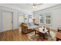 Cozy living room with hardwood floors, a comfortable sofa, and natural light at 1004 E 22Nd Ave, Tampa, FL 33605