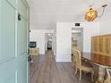 Open foyer with wood-look floors leading to the living room and kitchen at 11700 Park Blvd # 202, Seminole, FL 33772