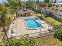 Outdoor community pool with plenty of seating and a pool house nearby at 11700 Park Blvd # 202, Seminole, FL 33772