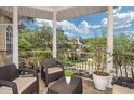 Spacious covered balcony includes comfortable seating and potted plants, perfect for outdoor enjoyment at 2308 W Jetton Ave, Tampa, FL 33629