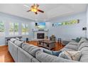 Spacious living room features a stone fireplace, tray ceiling, and hardwood floors at 2309 Valrico Forest Dr, Valrico, FL 33594