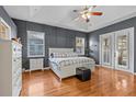 Charming main bedroom offers hardwood floors, ample natural light, and an ensuite bath at 2309 Valrico Forest Dr, Valrico, FL 33594