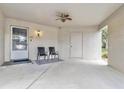 The large carport with ceiling fan and two seats provides ample space for parking and outdoor seating at 2646 Barksdale Ct, Clearwater, FL 33761