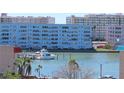 Waterfront view showcases a boat dock, calm waters, and residential buildings at 2960 59Th S St # 501, Gulfport, FL 33707
