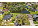 This home offers a serene backyard pond view and mature trees, providing privacy and natural beauty at 3629 Mossy Oak Cir, Land O Lakes, FL 34639