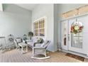 Cozy front porch with wicker seating and a decorative wreath on the front door at 3629 Mossy Oak Cir, Land O Lakes, FL 34639