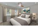 Serene bedroom with neutral tones, plush bedding, and large windows offering ample natural light at 370 S Woodlands Dr, Oldsmar, FL 34677