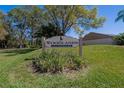 Woodlands Cluster III neighborhood sign, surrounded by greenery at 370 S Woodlands Dr, Oldsmar, FL 34677