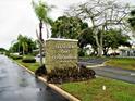 Exterior shot of the community sign for Clearview Oaks Condominiums with lush landscaping surrounding at 4153 57Th N St # 605, Kenneth City, FL 33709