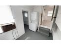 View of the utility area with washer, dryer and access to the main living spaces at 4851 W Gandy Blvd # B1L14, Tampa, FL 33611