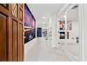 Bright hallway with white floors, an accent wall and leading to the kitchen and living area at 4950 26Th N Ave, St Petersburg, FL 33710