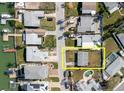 Aerial view showcases the property's layout, its proximity to surrounding neighborhood, and nearby canal at 596 S Bayshore Dr, Madeira Beach, FL 33708