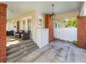 Spacious covered porch with outdoor seating, brick pillars, and access to a convenient carport area at 803 S Packwood Ave, Tampa, FL 33606