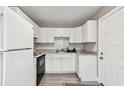 Clean kitchen showcases white cabinets, subway tile backsplash and modern stove at 803 W Warren St, Plant City, FL 33563