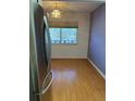 Open dining area featuring laminate flooring and natural light from the large window at 8402 111Th St # 303, Seminole, FL 33772