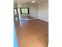 Bright living room with laminate flooring, ceiling fan, and large windows with exterior views at 8402 111Th St # 303, Seminole, FL 33772