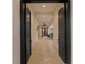 Inviting hallway with travertine floors leading to an outdoor patio with comfortable seating and lush tropical views at 926 Anchorage Rd, Tampa, FL 33602