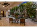 Secluded backyard with a dark bottom pool, waterfall feature and lush tropical foliage creating a private retreat at 926 Anchorage Rd, Tampa, FL 33602