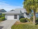 Charming single-Gathering home featuring a two-car garage and inviting entryway at 1020 Lake Avoca Dr, Tarpon Springs, FL 34689