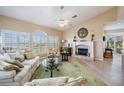 Bright living room with fireplace, neutral walls, and large windows overlooking the water at 104 Westbrook Ct, Safety Harbor, FL 34695