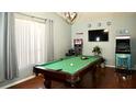 Spacious game room featuring a pool table, arcade games, and a mounted television for entertainment at 10440 Laval St, Spring Hill, FL 34608