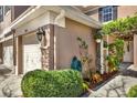 Manicured yard with green shrubbery, foliage, and brick pillar at the front entrance at 11190 Windsor Place Cir, Tampa, FL 33626