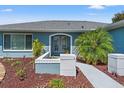 Inviting front entrance featuring a tiled walkway and mature landscaping elements at 11207 Allwood St, Spring Hill, FL 34609