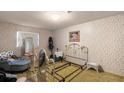Cozy bedroom with floral wallpaper, mirrored vanity, and comfortable sitting area at 11327 Carter Grove Ln, Thonotosassa, FL 33592