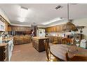 Spacious kitchen features wood cabinets, island, brick floors, and modern appliances at 11327 Carter Grove Ln, Thonotosassa, FL 33592