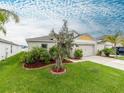 Inviting single-Gathering home boasts a beautifully landscaped front yard, enhancing its curb appeal at 12635 Tannencrest Dr, Riverview, FL 33579