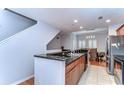 Well-equipped kitchen area with granite countertops, wooden cabinets, and stainless steel appliances at 133 S Sherrill St # 133, Tampa, FL 33609