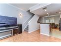 Open-concept living space with modern finishes, stairs, wood floors, and a view of the kitchen area at 133 S Sherrill St # 133, Tampa, FL 33609