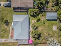 Aerial view showcases the home's new metal roof, lush landscaping, and fenced yard at 1740 Grove Dr, Clearwater, FL 33759