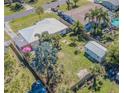 Aerial view highlighting the fenced yard, landscaping, shed, and outdoor space of the home at 1740 Grove Dr, Clearwater, FL 33759