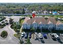 Aerial view of well-manicured townhome community boasting lush landscaping and convenient parking at 1811 Fluorshire Dr, Brandon, FL 33511