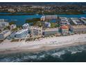Stunning aerial view of beachfront condos, pool, tennis courts and coastline at 19451 Gulf Blvd # 301, Indian Shores, FL 33785