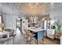 Stylish kitchen with modern island, stainless steel appliances, and stone accent wall at 24862 Us Highway 19 N # 1701, Clearwater, FL 33763