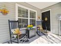 Inviting front porch featuring rocking chairs and welcoming sunflower decorations at 3002 Mojave Oak Dr, Valrico, FL 33594