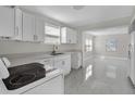Modern kitchen featuring white cabinetry, sleek countertops, and stainless steel appliances, designed for style and functionality at 304 E Hanlon St, Tampa, FL 33604