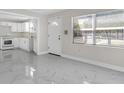 Bright living room with marble tile flooring and a view of the adjacent updated kitchen at 304 E Hanlon St, Tampa, FL 33604