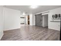 Spacious living room featuring modern flooring, a sliding barn door, and neutral paint at 3684 14Th Se Ave, Largo, FL 33771