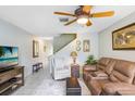 Inviting living room with a ceiling fan, comfortable seating, and a tiled floor, perfect for relaxing and entertaining at 435 Kensington Lake Crk, Brandon, FL 33511