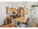 Open kitchen boasts granite countertops, stainless appliances, and wooden cabinetry at 5088 Royal Palms Way # 304, New Port Richey, FL 34652