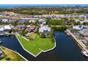 Waterfront home with a lush lawn, boat dock, and stunning views of the surrounding community and waterways at 708 Islebay Dr, Apollo Beach, FL 33572